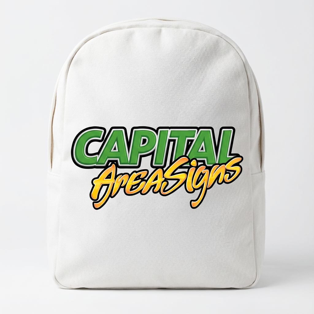 White canvas backpack featuring DTF transfer with green gradient "CAPITAL" and orange gradient "AreaSigns" logo on front center, professional product photography