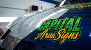 Close-up of vehicle wrap installation by Capital Area Signs in Austin TX