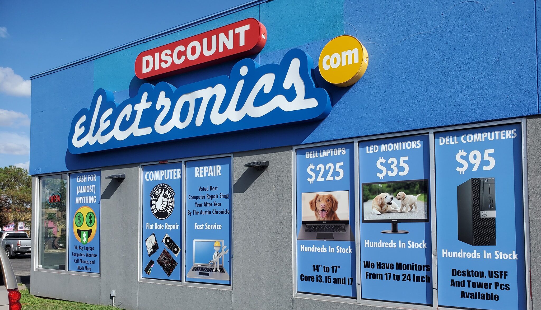 Exterior business sign and window graphics on a storefront